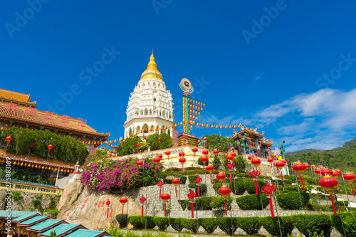 Yellow roof of Kek Lok Si Temple with Penang cityscape in Penang island, Malaysia photo