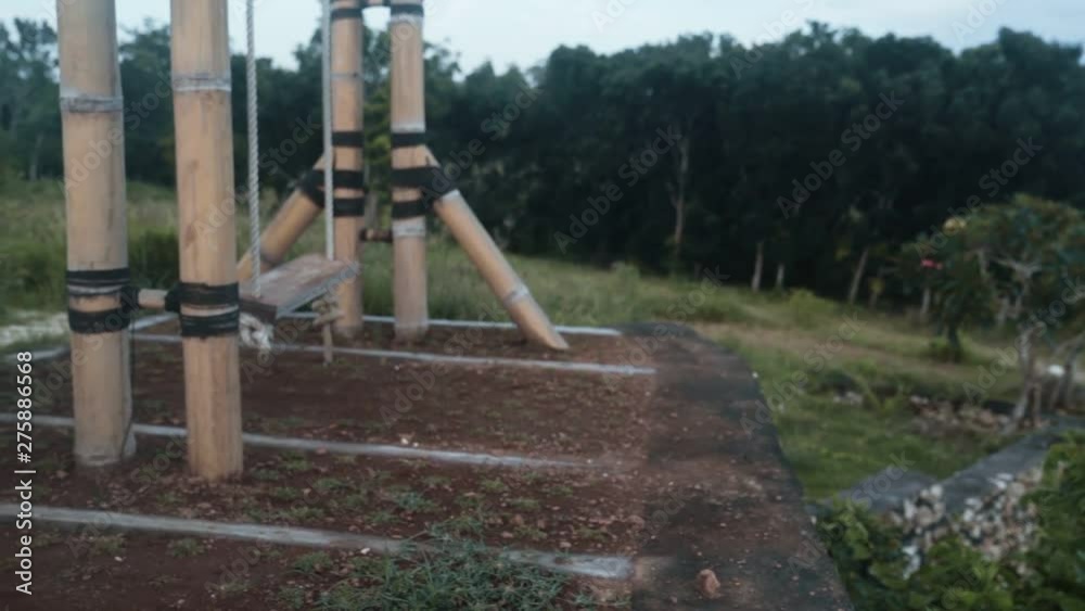 Close up, legs of young woman swings on swing on nature, slow motion Close up, legs of young woman swings on swing on nature, slow motion