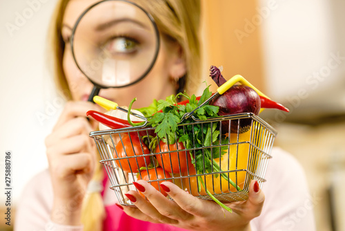 Woman investigating shopping backet with vegetables