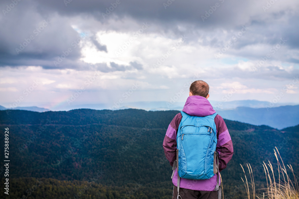 Man traveler in mountains enjoying aerial view. Man traveler in mountains enjoying aerial view.