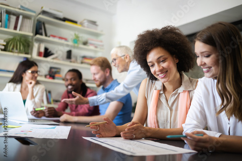 Cheerful coworkers in office during company meeting