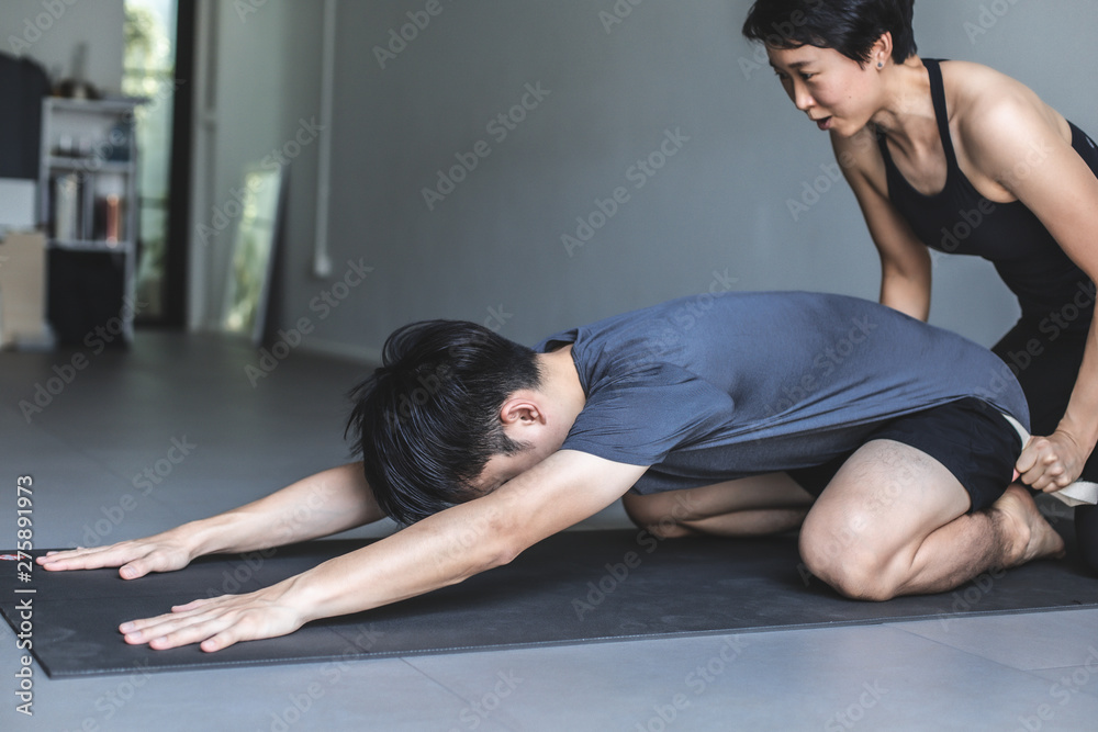 Young woman practicing yoga in  gray background.Young people do yoga indoor