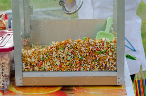 sweet colored popcorn in a machine for cooking in nature