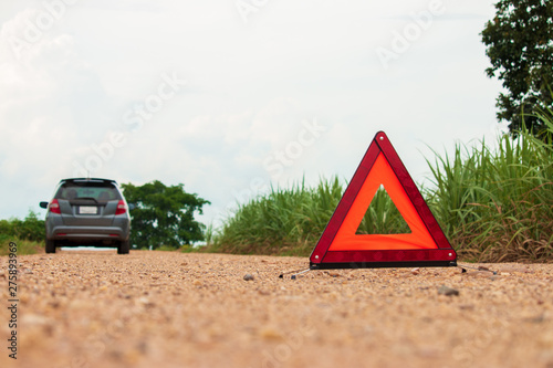 Red warning triangle. Focus on red triangle!, beside rural road.