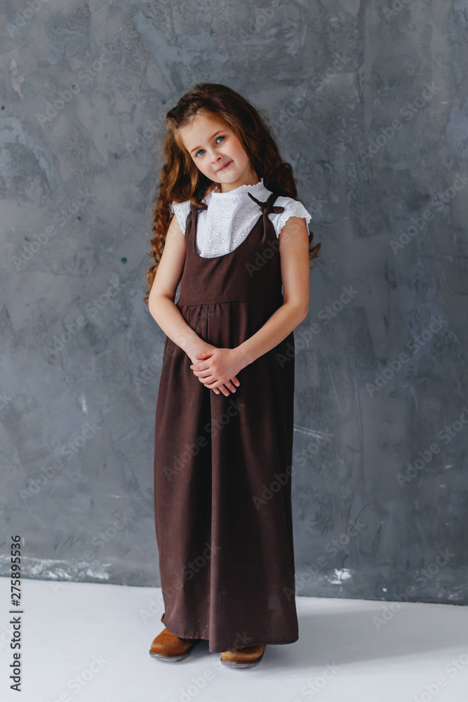 A girl in a long old fashioned dress with long hair A girl in a long old fashioned dress with long hair