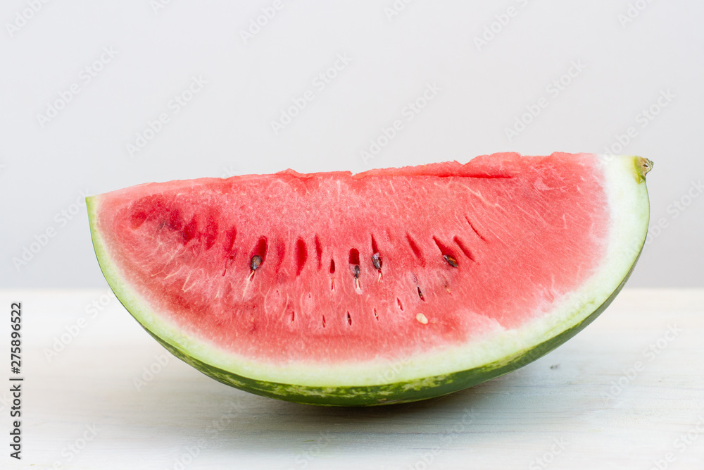 a slice watermelon on white table a slice watermelon on white table