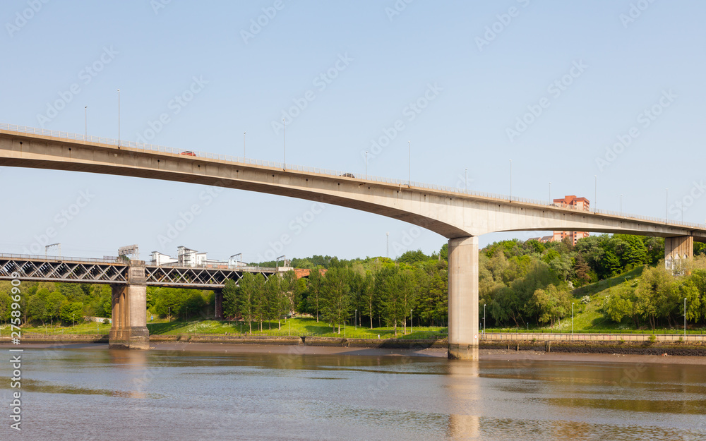 Traffic is seen crossing Redheugh Bridge over the River Tyne and in the background is the King Edward VII railway bridge. The bridges connect Newcastle upon Tyne and Gateshead. Traffic is seen crossing Redheugh Bridge over the River Tyne and in the background is the King Edward VII railway bridge. The bridges connect Newcastle upon Tyne and Gateshead.