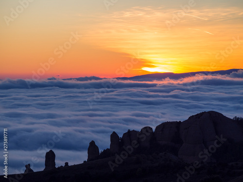 Sunset over the foggy valley