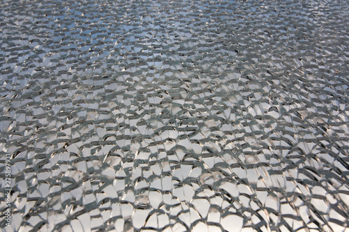 The texture of the broken cracked fragile broken glass with small fragments