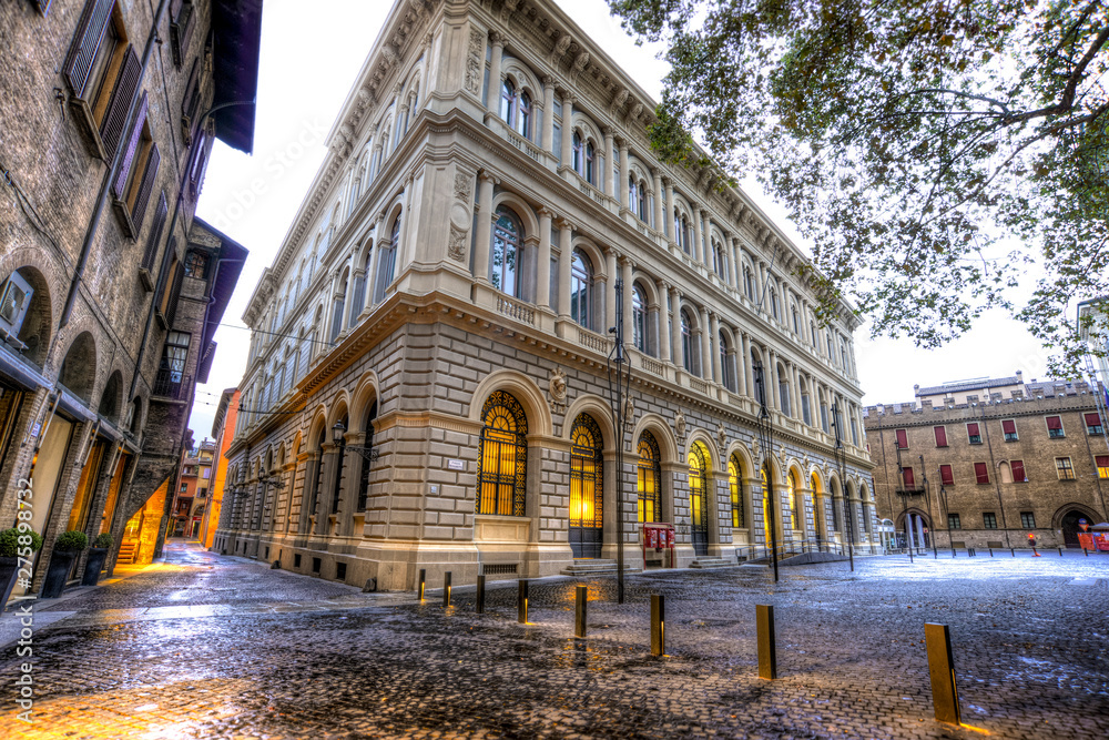 White old building with yellow arcade in Minghetti square in Bologna city in Italy
