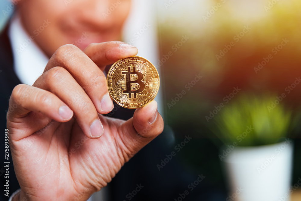 Fototapeta premium Business man hand holding show crypto bitcoin currency money