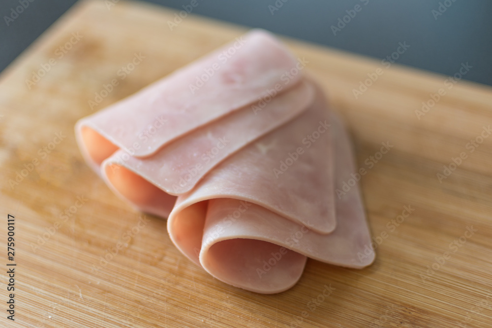 Sliced bacon on wooden background. Fresh prosciutto. Pork ham sliced. Sliced bacon on wooden background. Fresh prosciutto. Pork ham sliced.