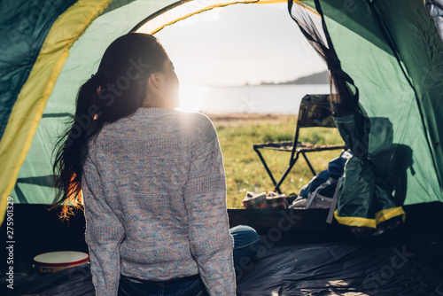 Back one woman inside view camping tent in summer