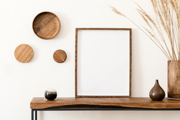 Design scandinavian interior of living room with wooden console, rings on the wall, mock up poster frame, flowers in vase and elegant personal accessories. Modern home decor. Template.