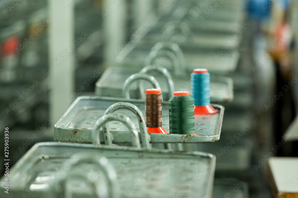 multicolored cotton sewing tread spool in a clothing factory multicolored cotton sewing tread spool in a clothing factory