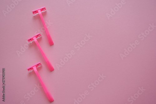 Means for hair removal on a colored background. Modern razor on a colored background. Removal of unwanted hair. Minimalism, choice, top view, flatlay.