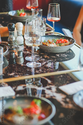 Close-up of food and wine glass on dining table in restaurant