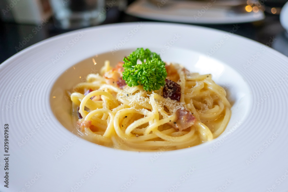Pasta carbonara or spaghetti with ham, parsley, bacon, parmesan cheese in white dish. Pasta carbonara or spaghetti with ham, parsley, bacon, parmesan cheese in white dish.