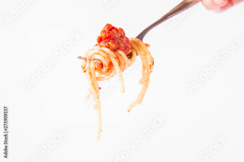 Spaghetti bolognese on a fork on a white background 
