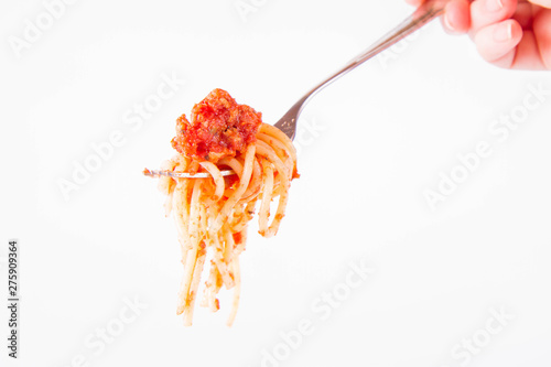 Spaghetti bolognese on a fork on a white background 