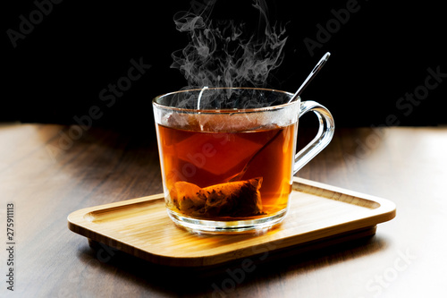 Hot herbal tea in dark background