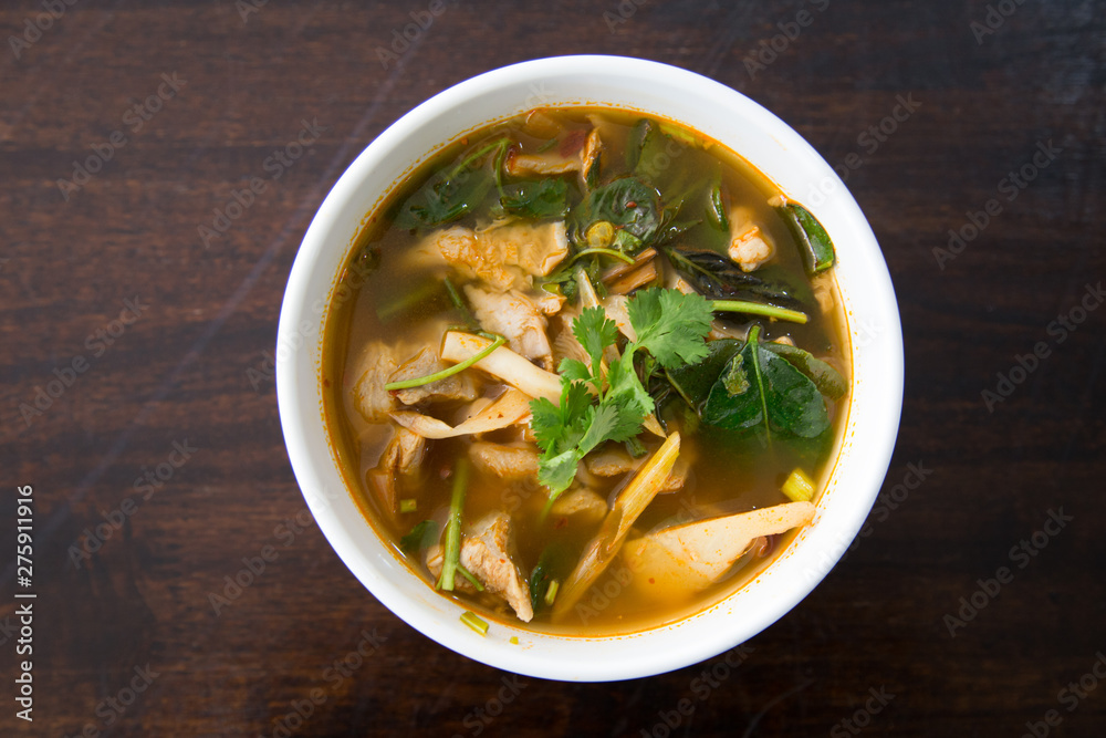 Hot and spicy pork bone with tamarind and Thai herbs soup on bowl Hot and spicy pork bone with tamarind and Thai herbs soup on bowl