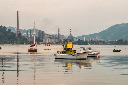 Zonguldak eregli district, fishing boats and erdemir iron and steel factory behind June 24,2019, Eregli, Zonguldak, Turkey photo