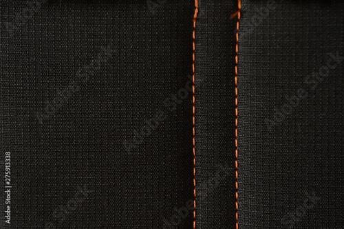 Black polyester stitched orange fabric texture