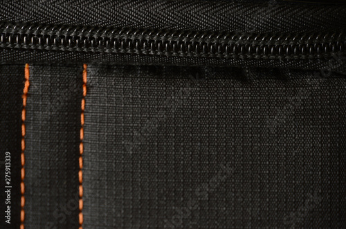 Black polyester stitched orange fabric texture