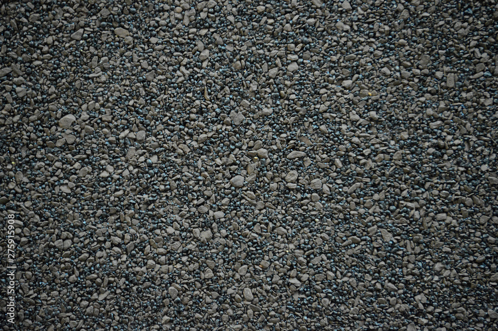 The texture of the rubberized asphalt crumb on the treadmill. The roof of the building is covered with concrete and resin. Background small pieces of brick The texture of the rubberized asphalt crumb on the treadmill. The roof of the building is covered with concrete and resin. Background small pieces of brick