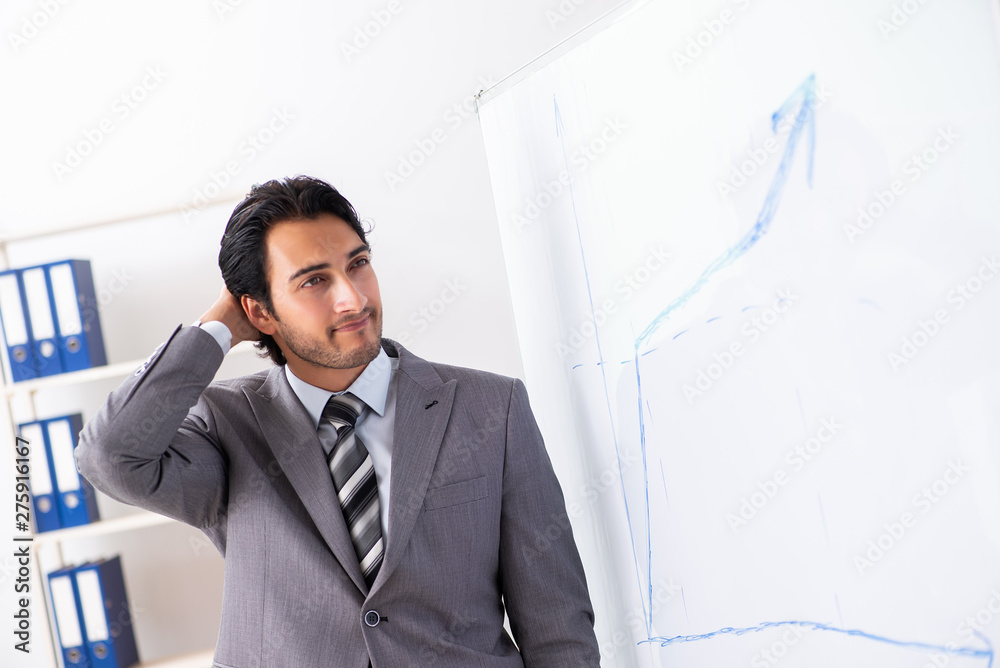 Young handsome businessman in front of whiteboard Young handsome businessman in front of whiteboard