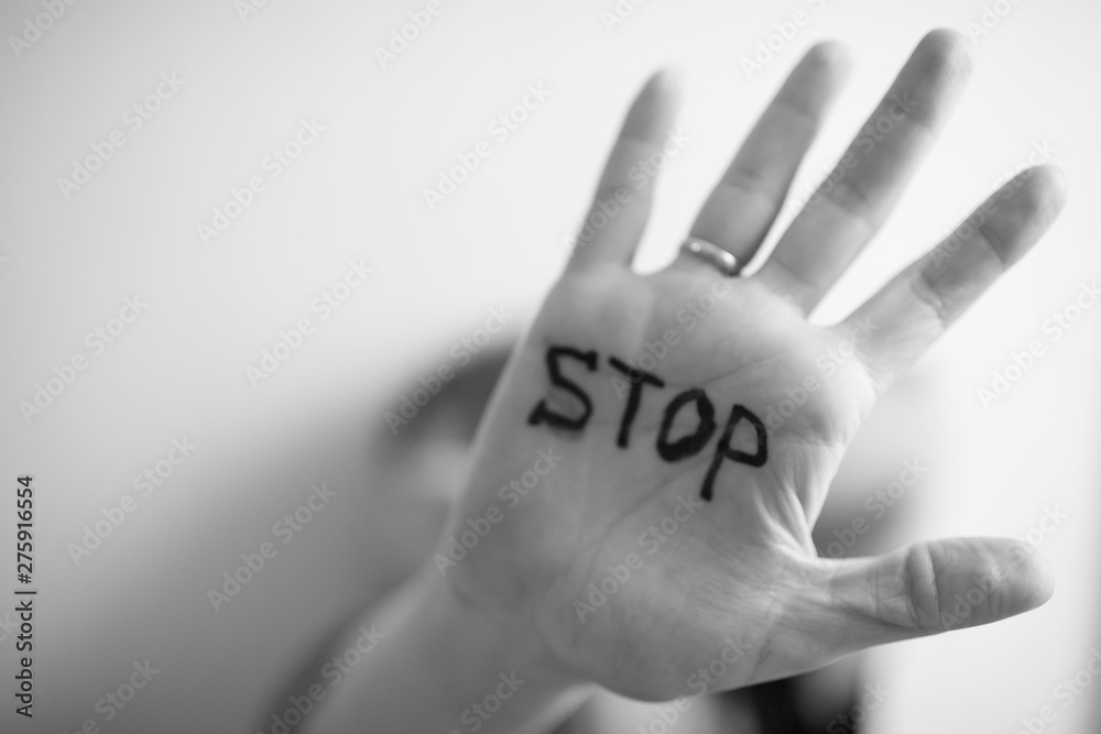 Woman shows palm with the inscription on the palm "Stop" - obrazy, fototapety, plakaty 