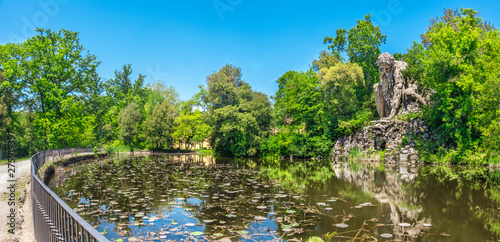 The majestic big statue of Colosso dell Appennino giant statue and pond in public gardens of Pratolino near Florence in Italy - panoramic wide shot photo