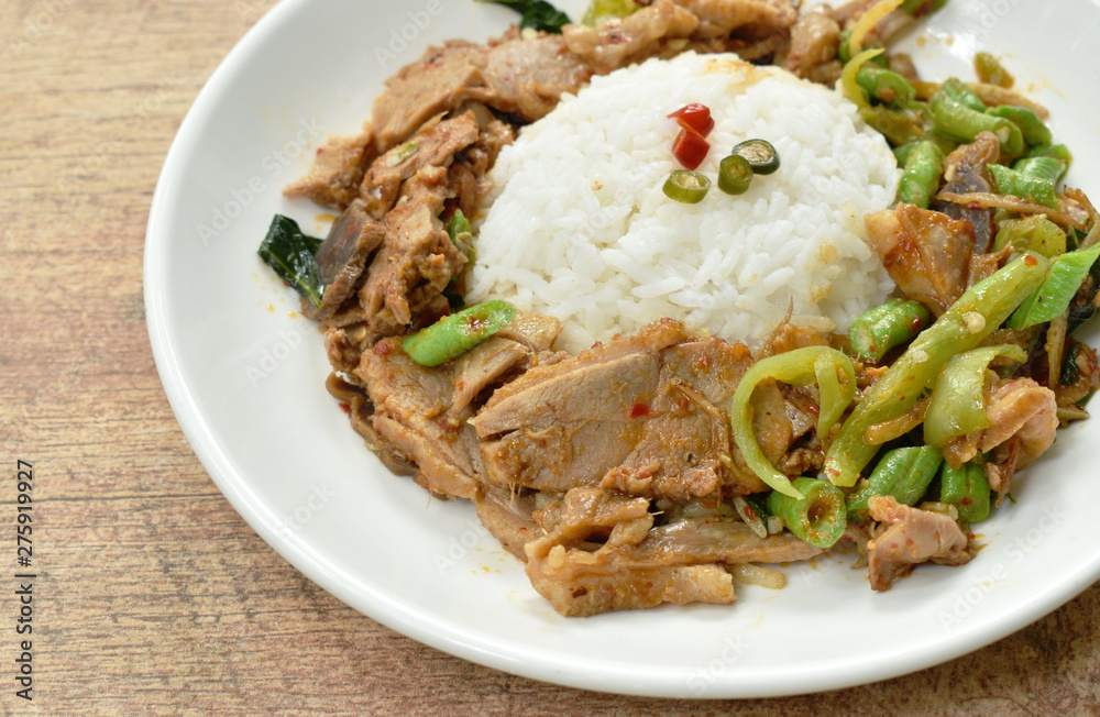 spicy stir fried duck meat curry on rice in plate