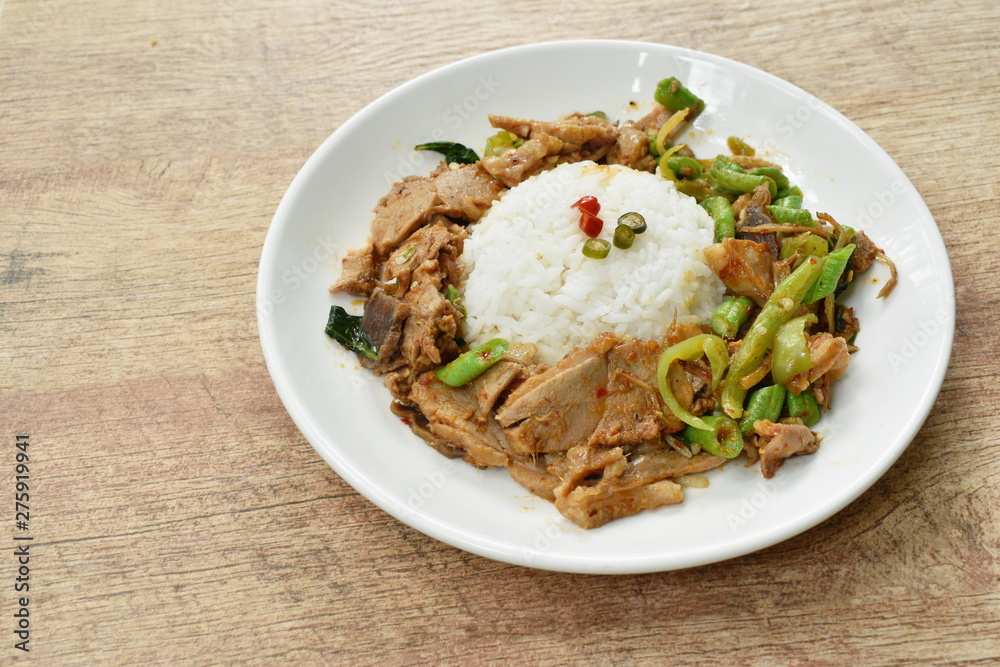 spicy stir fried duck meat curry on rice in plate