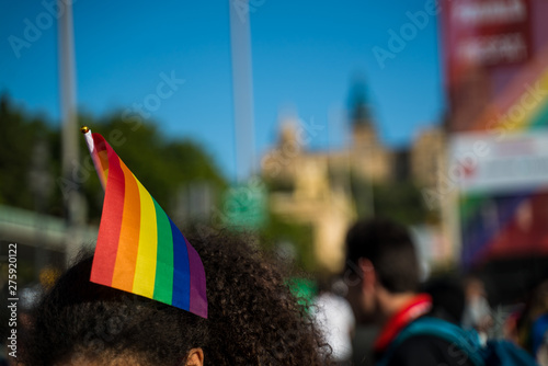 Rainbow flag in the hair. Girl wearing LGBTQ flag in her hair. Gay pride in Barcelona.