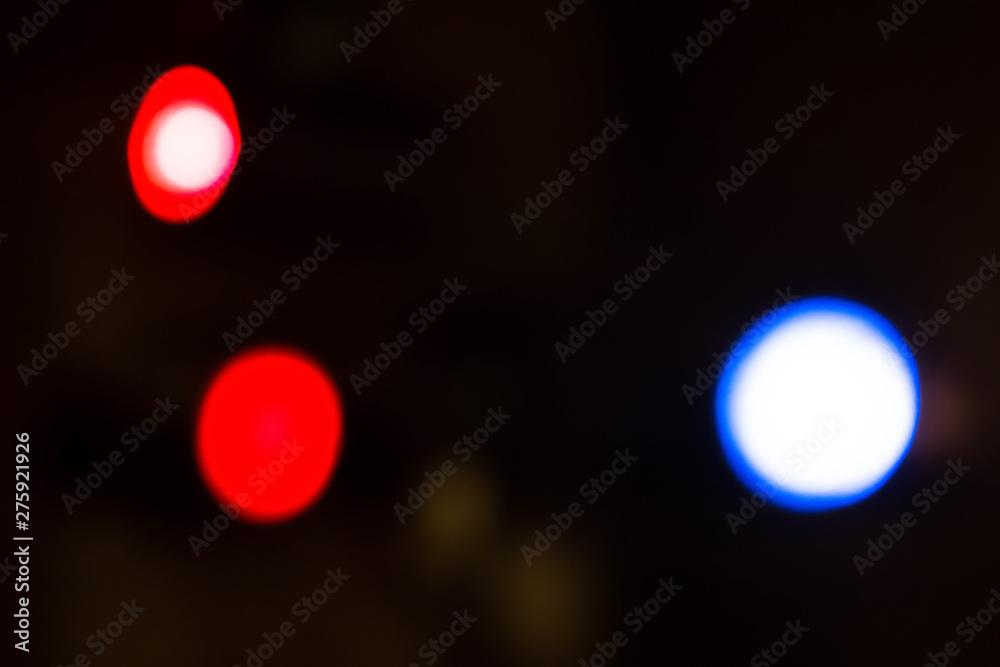 Three multi-colored blurry defocused lights. Red and blue light spotlights, bokeh. Abstract background of colorful lights. Bright spots, a pattern of blurry flashlights. Three multi-colored blurry defocused lights. Red and blue light spotlights, bokeh. Abstract background of colorful lights. Bright spots, a pattern of blurry flashlights.