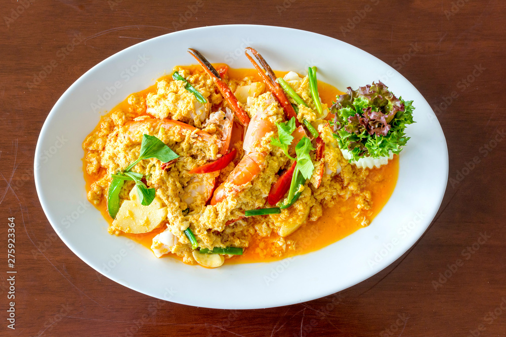 Stir fried shrimp or prawn in curry powder the famous delicious Thai food on white background Stir fried shrimp or prawn in curry powder the famous delicious Thai food on white background