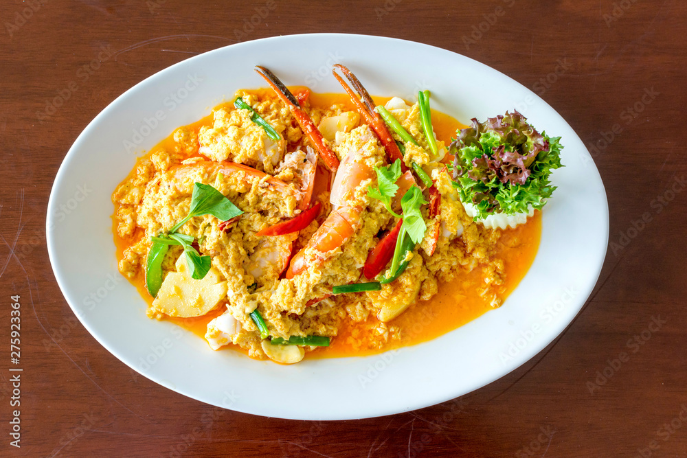 Stir fried shrimp or prawn in curry powder the famous delicious Thai food on white background