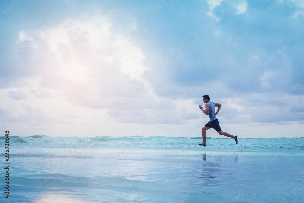 Man running athletes at the beach with sunset background. Man running athletes at the beach with sunset background.