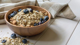 oatmeal with blueberries, almond and walnuts in a wooden bowl on a black wooden table