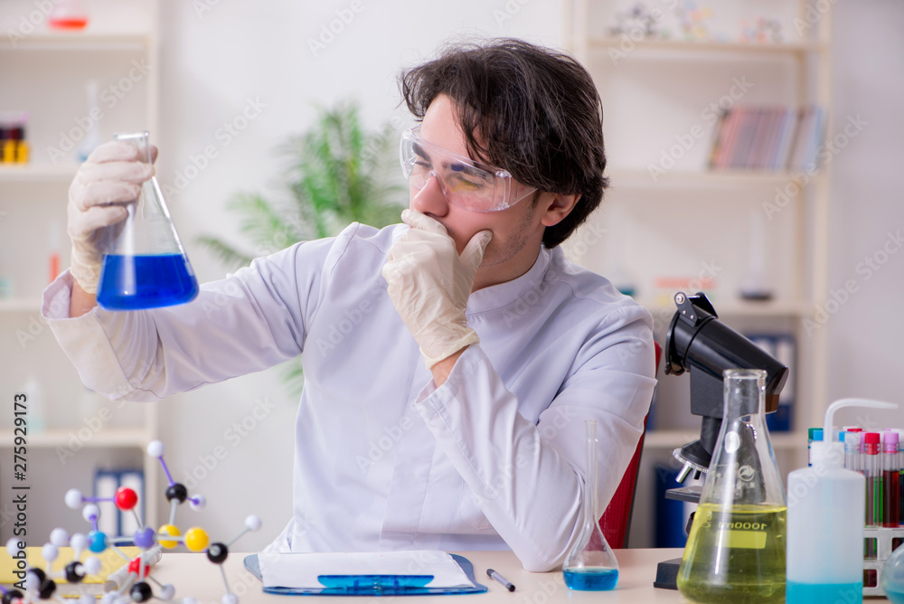 Young male biochemist working in the lab Young male biochemist working in the lab