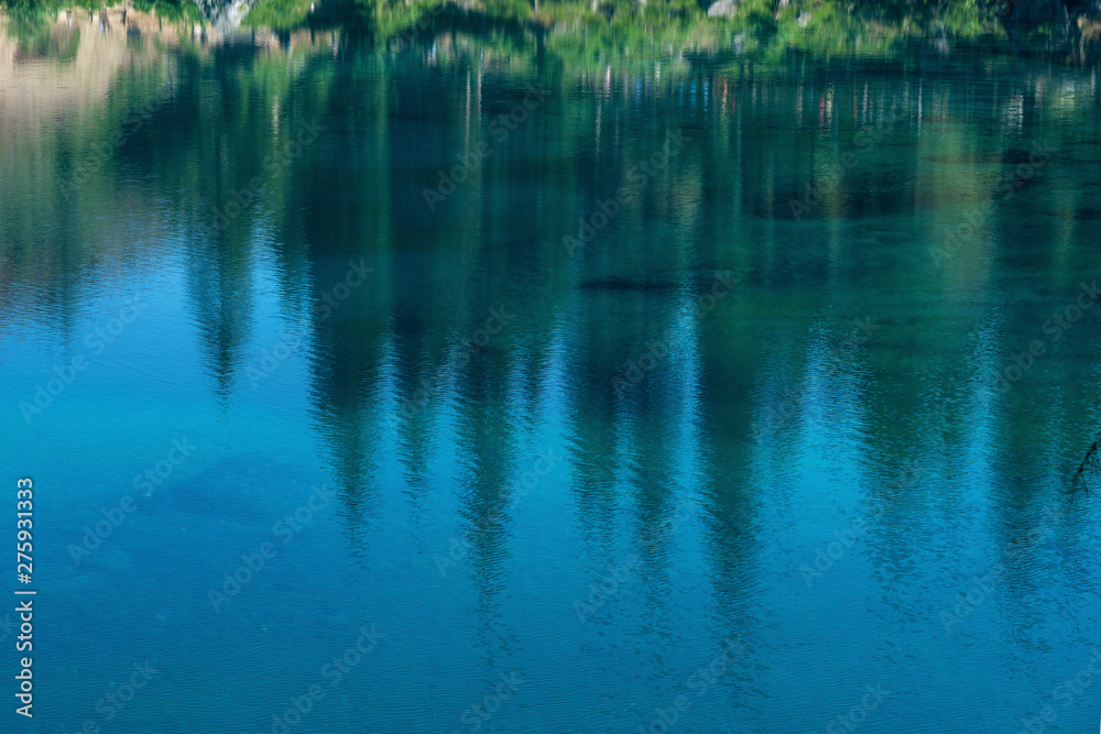 Lake Caress Dolomites Italy. Lake of Caresse in Italy. Scenic place and famous touristic destination. Primeval nature Lake Caress Dolomites Italy. Lake of Caresse in Italy. Scenic place and famous touristic destination. Primeval nature