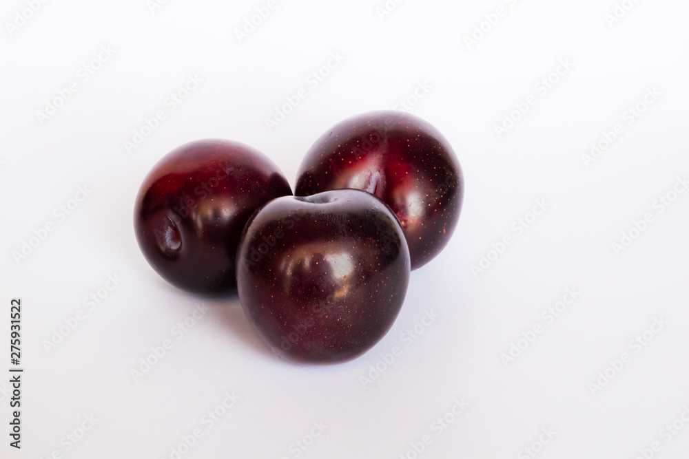 close up of red cherry plums isolated