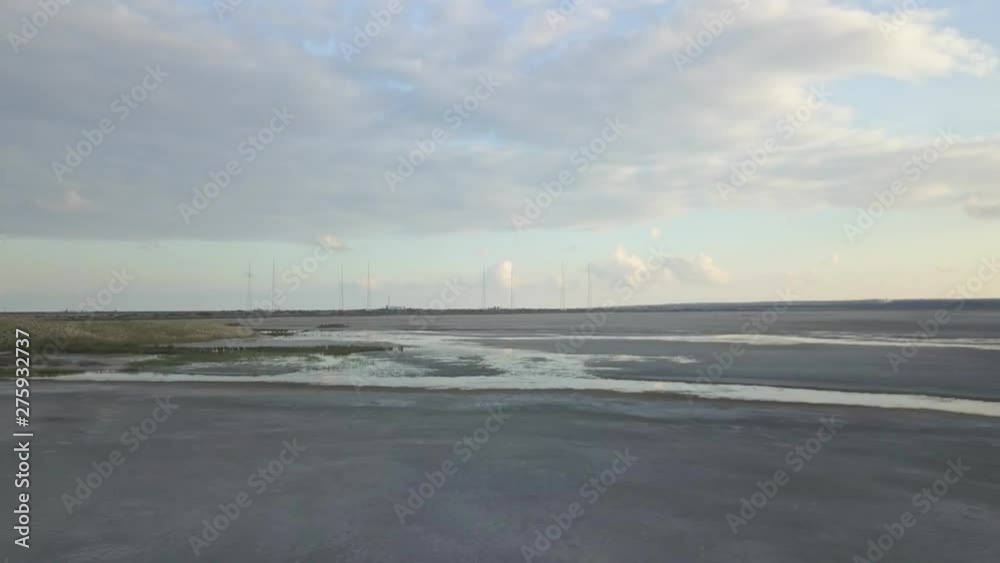 Flight over surface of Limassol Salt Lake (Akrotiri Salt Lake) with a scenic sunset view. Aerial of wetland. Flight over surface of Limassol Salt Lake (Akrotiri Salt Lake) with a scenic sunset view. Aerial of wetland.