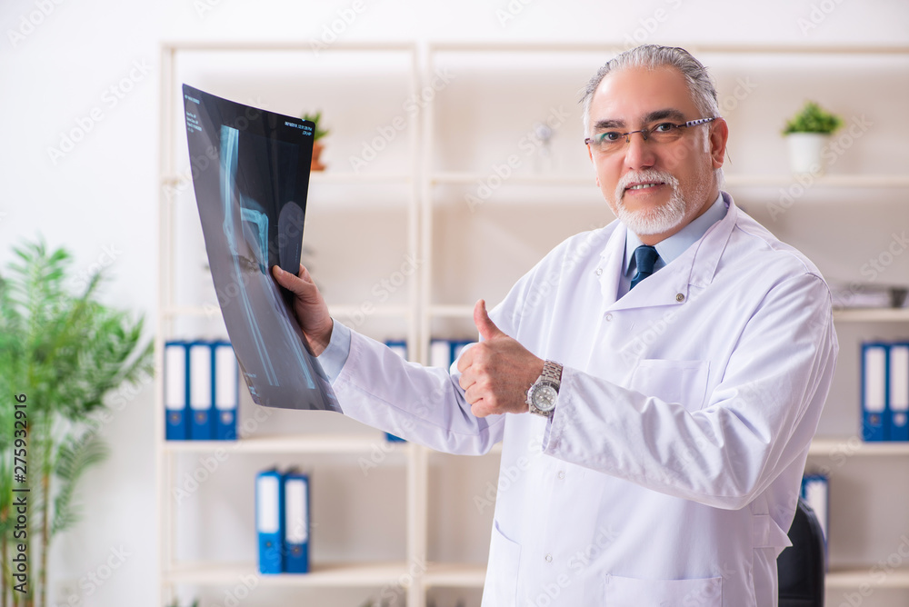 Aged male doctor radiologist in the clinic Aged male doctor radiologist in the clinic