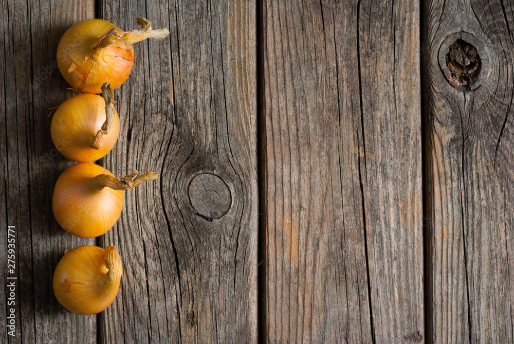 onions on weathered wooden table background onions on weathered wooden table background