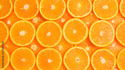 Slices of oranges as a background, top view.