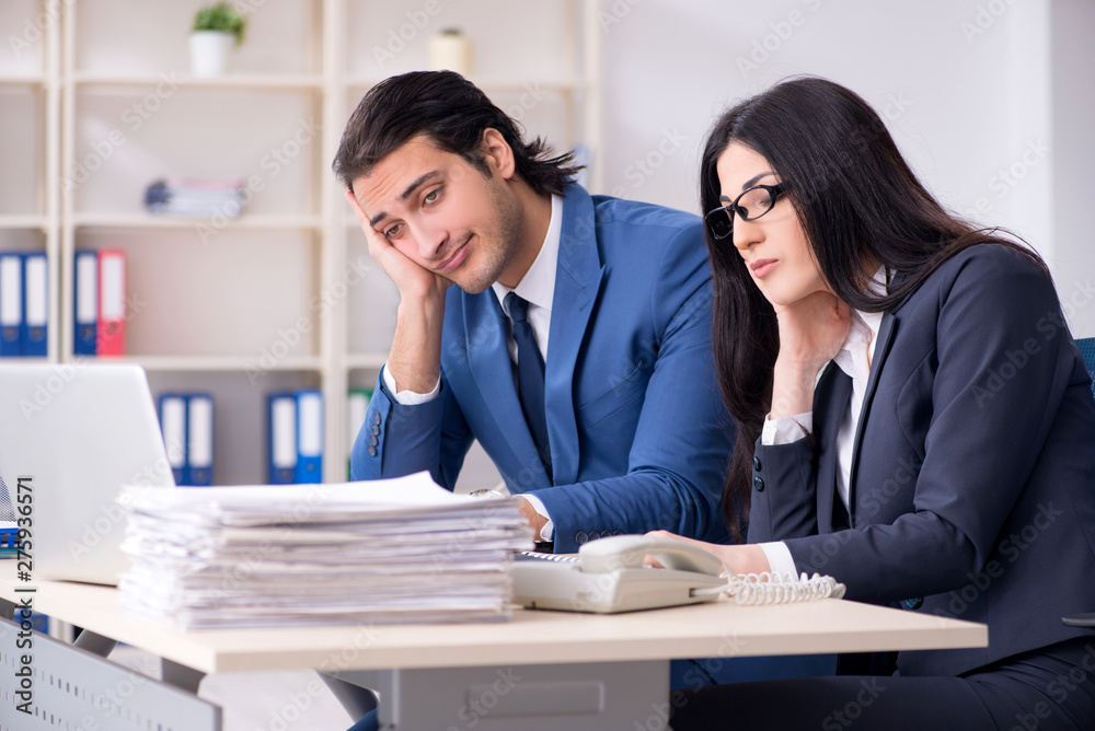 Two employees working in the office Two employees working in the office