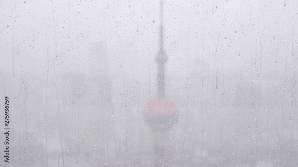 Rain water drops falling on windows glass in summer, slow motion, 4k footage, heavy rain fall with Shanghai Bund landmarks background. Rain water drops falling on windows glass in summer, slow motion, 4k footage, heavy rain fall with Shanghai Bund landmarks background.